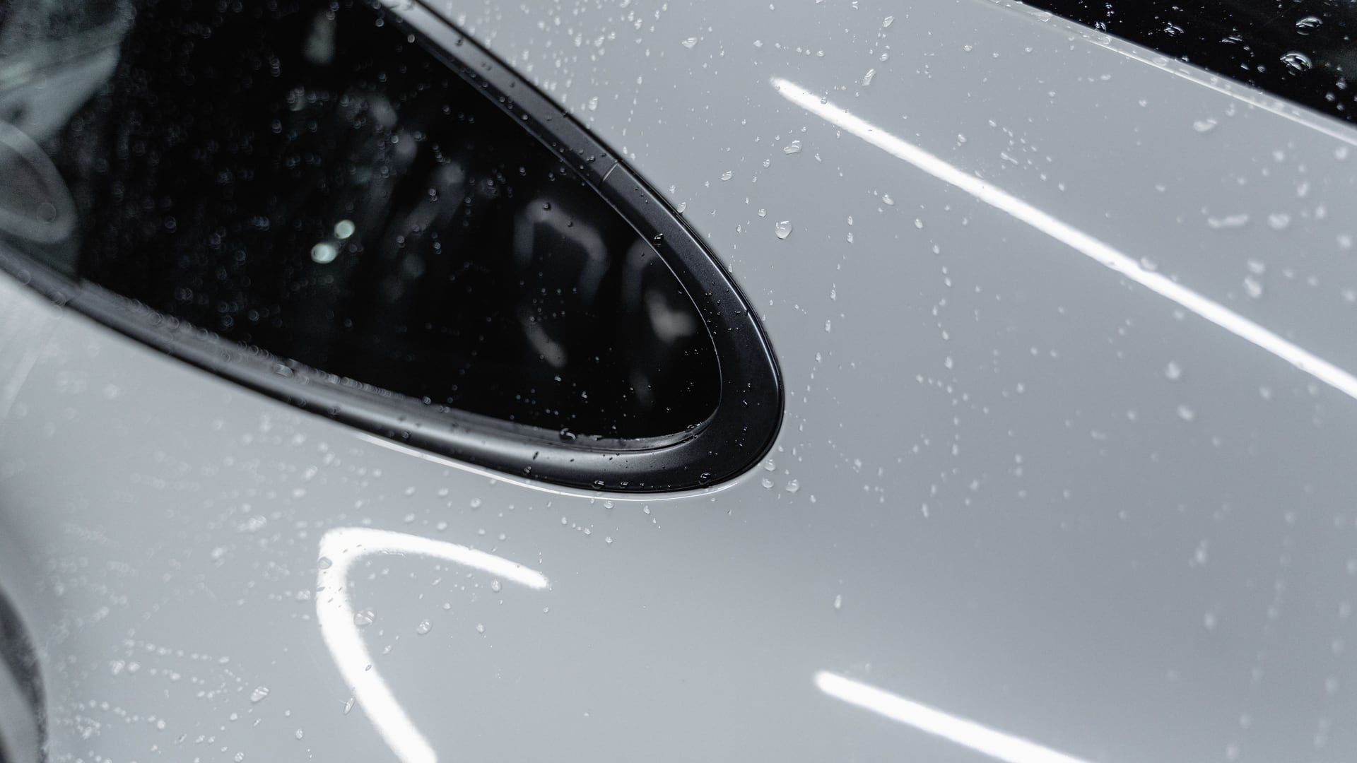 Water beading across the clean paint of a finished vehicle